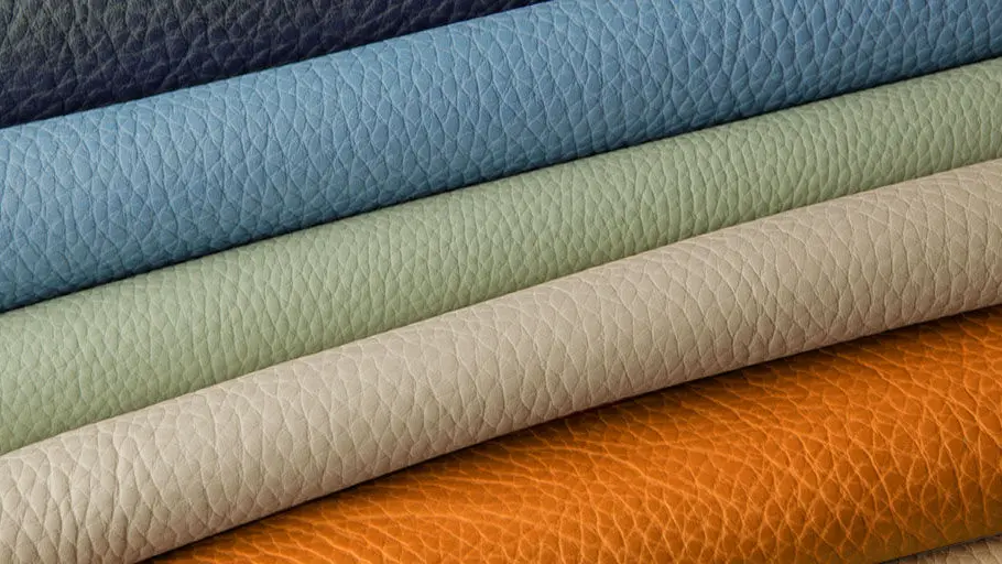 Stos kolorowych arkuszy skóry o charakterystycznej ziarnistej fakturze